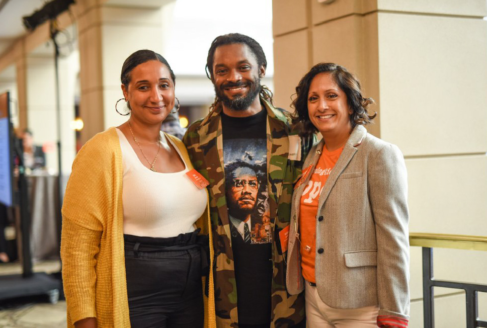 Two women and one man with nametags pose at a greater diversity in education leadership conference, smiling (Education Leaders of Color, Annual Letter, CZI).