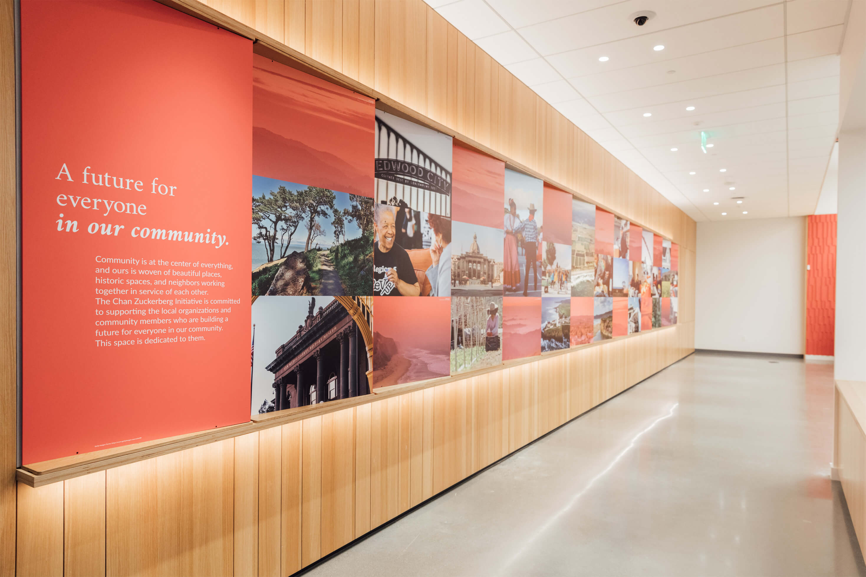 Photo of CZI Community Space, showing long wall with checkered images of people, buildings, and coastal scenery, and a dedication to "A future for everyone in our community."