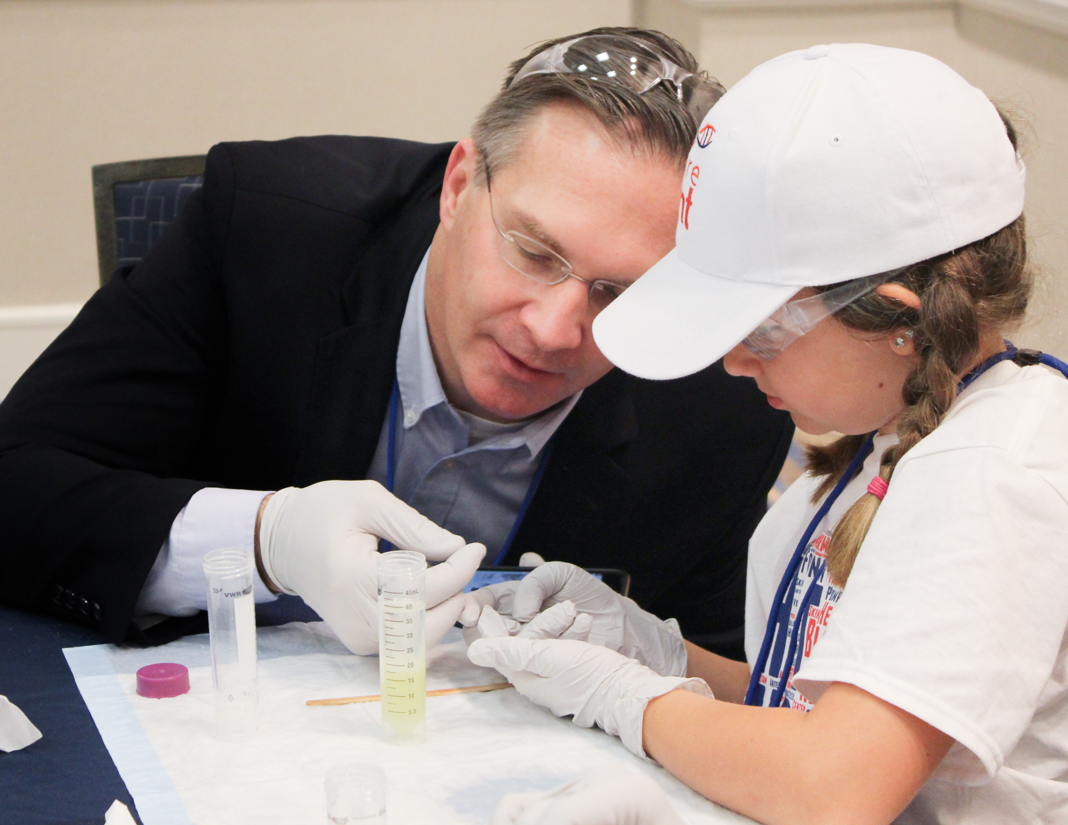 Dr. Joshua Murphy (left) speaking with a young female patient (right)