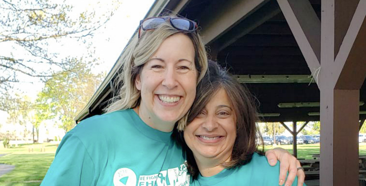 The EHE Foundation's Executive Director Medha Deoras-Sutliff (right) poses with Board President Jenni Kovach (left) outside
