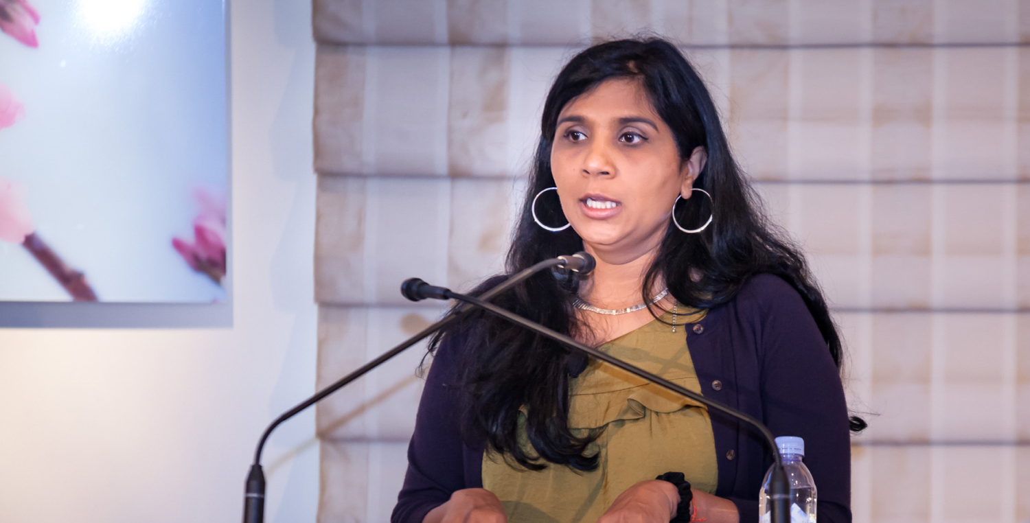 Rashmi Sinha speaks at a lectern