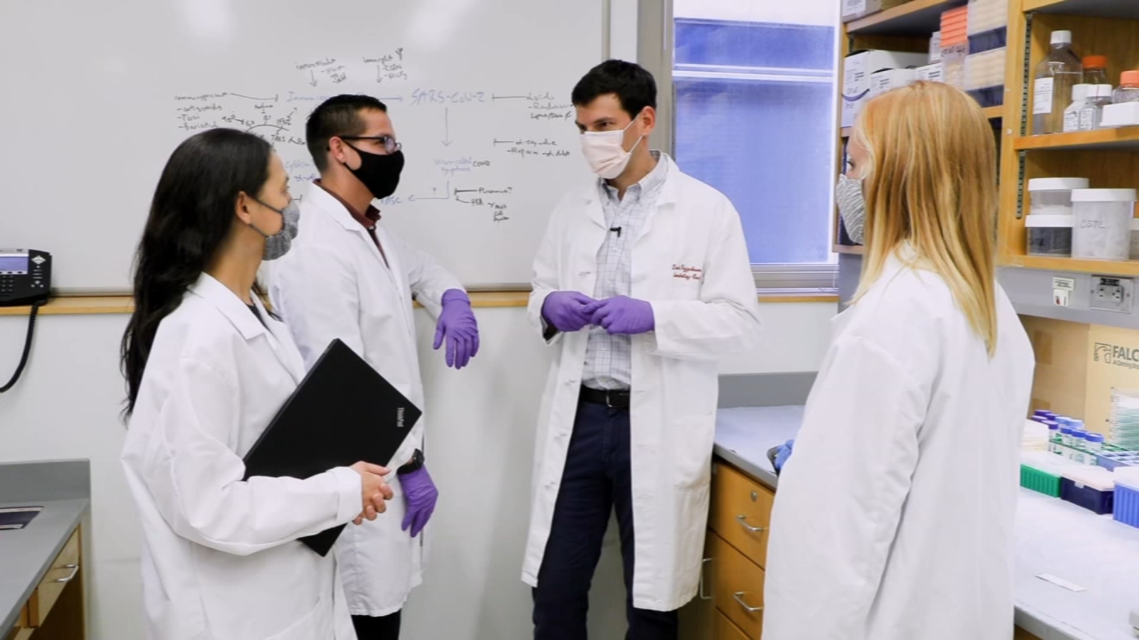 David Fajgenbaum, Co-Founder & Executive Director of the Castleman Disease Collaborative Network working in his lab alongside colleagues
