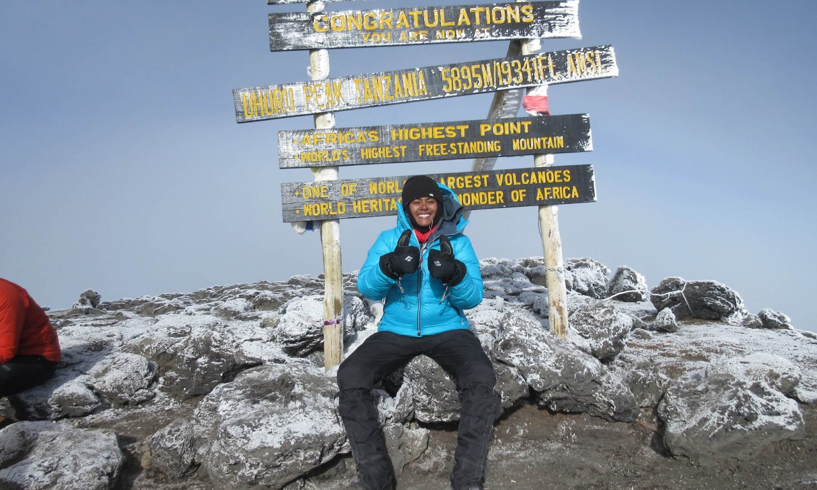 Lauren Turner smiles after reaching the top of Mount Kilimanjaro