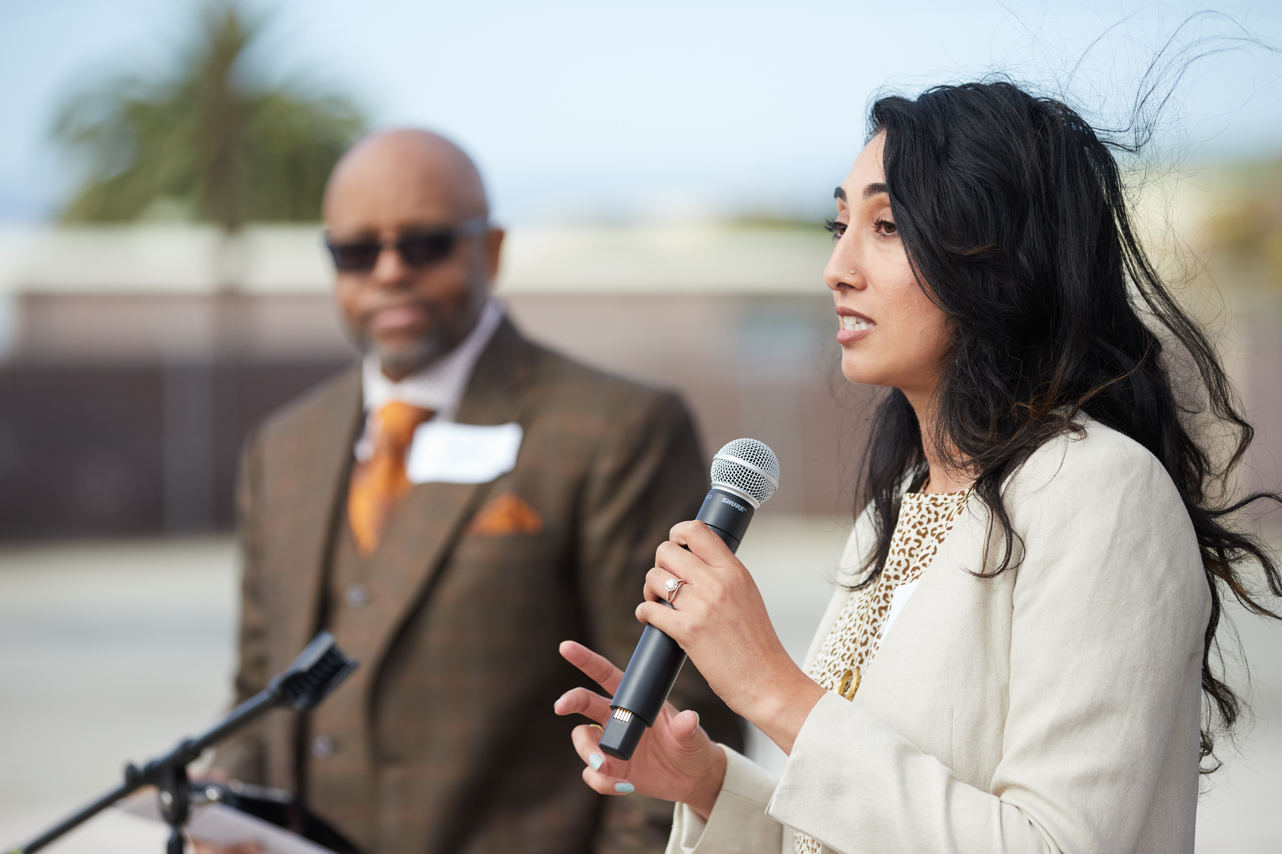 Ruby Bolaria Shifrin speaking at the United Hope Builders groundbreaking event with indieDwell