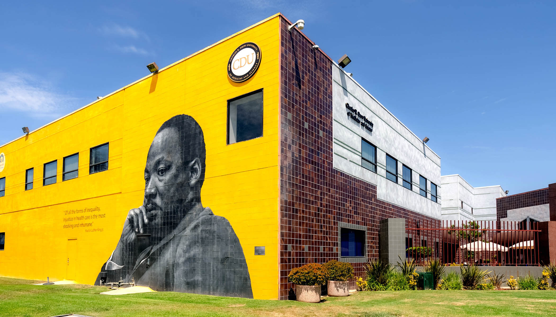 A mural of Dr. Martin Luther King, Jr. on the side of a brick building.