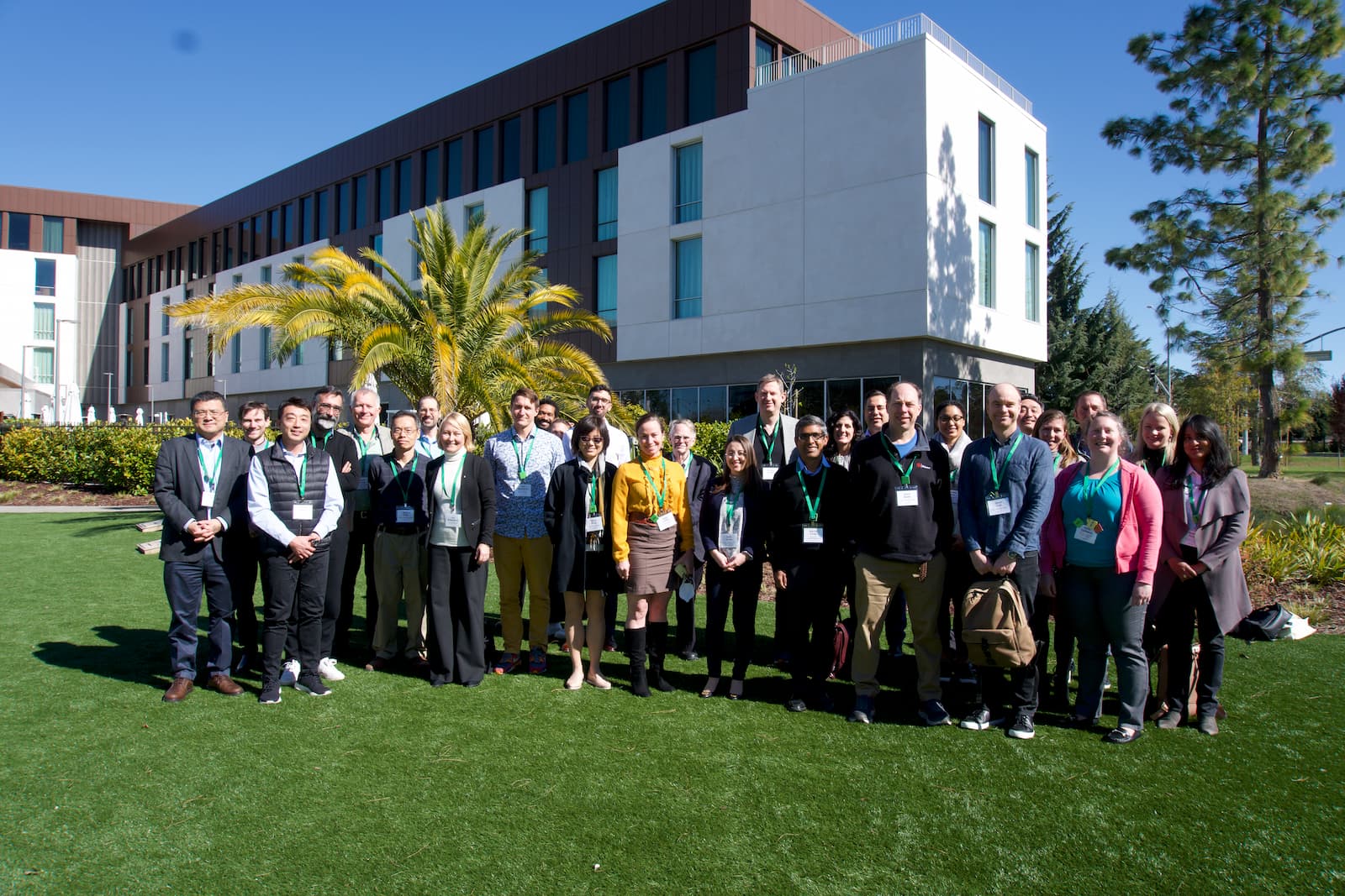 A group of participants at CZI's Metabolism Across Scales Workshop stand side by side and smile at the camera.