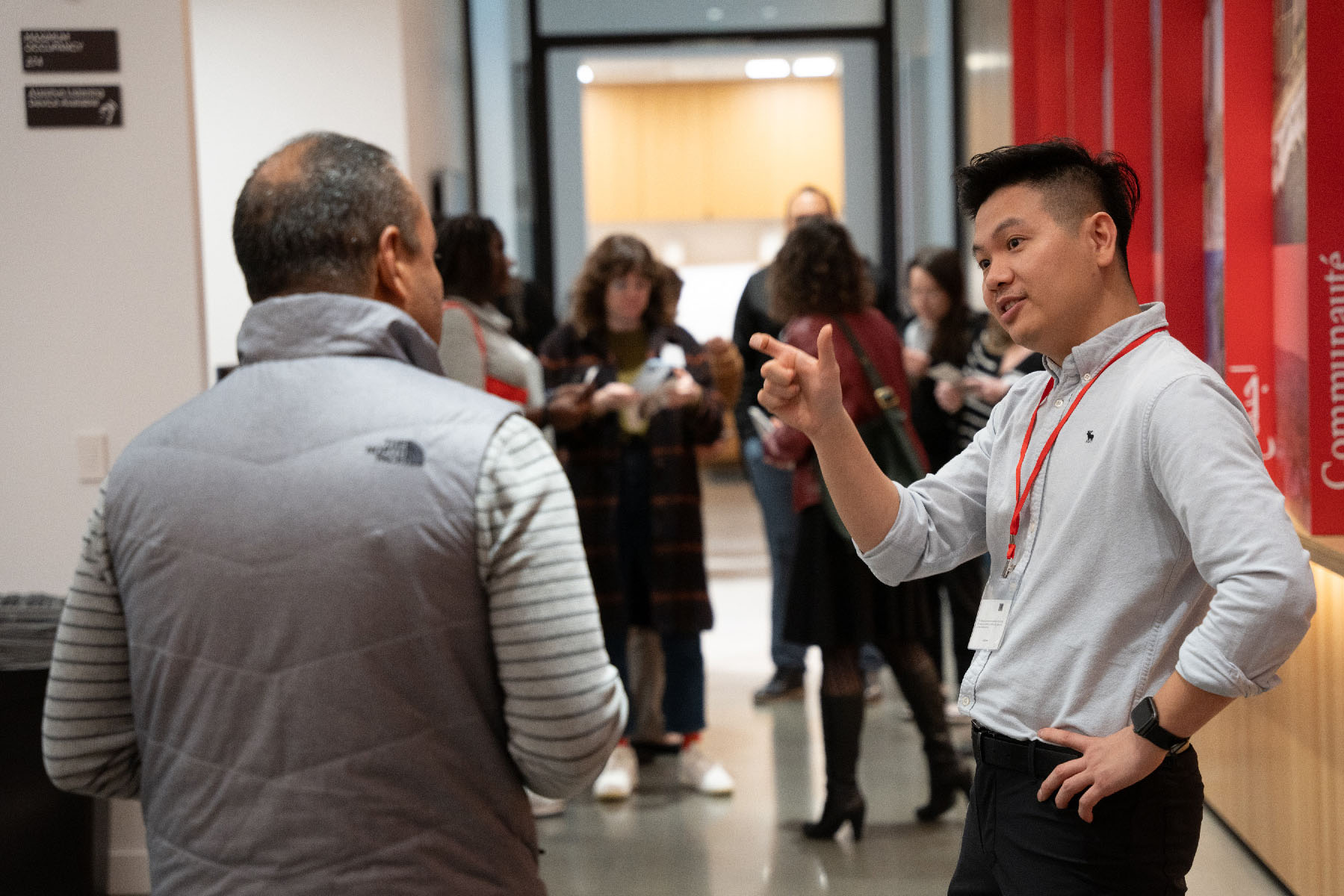 Community Programs Manager Jeremy Nguyen welcomes a community member to an Open House in the CZI Community Space.