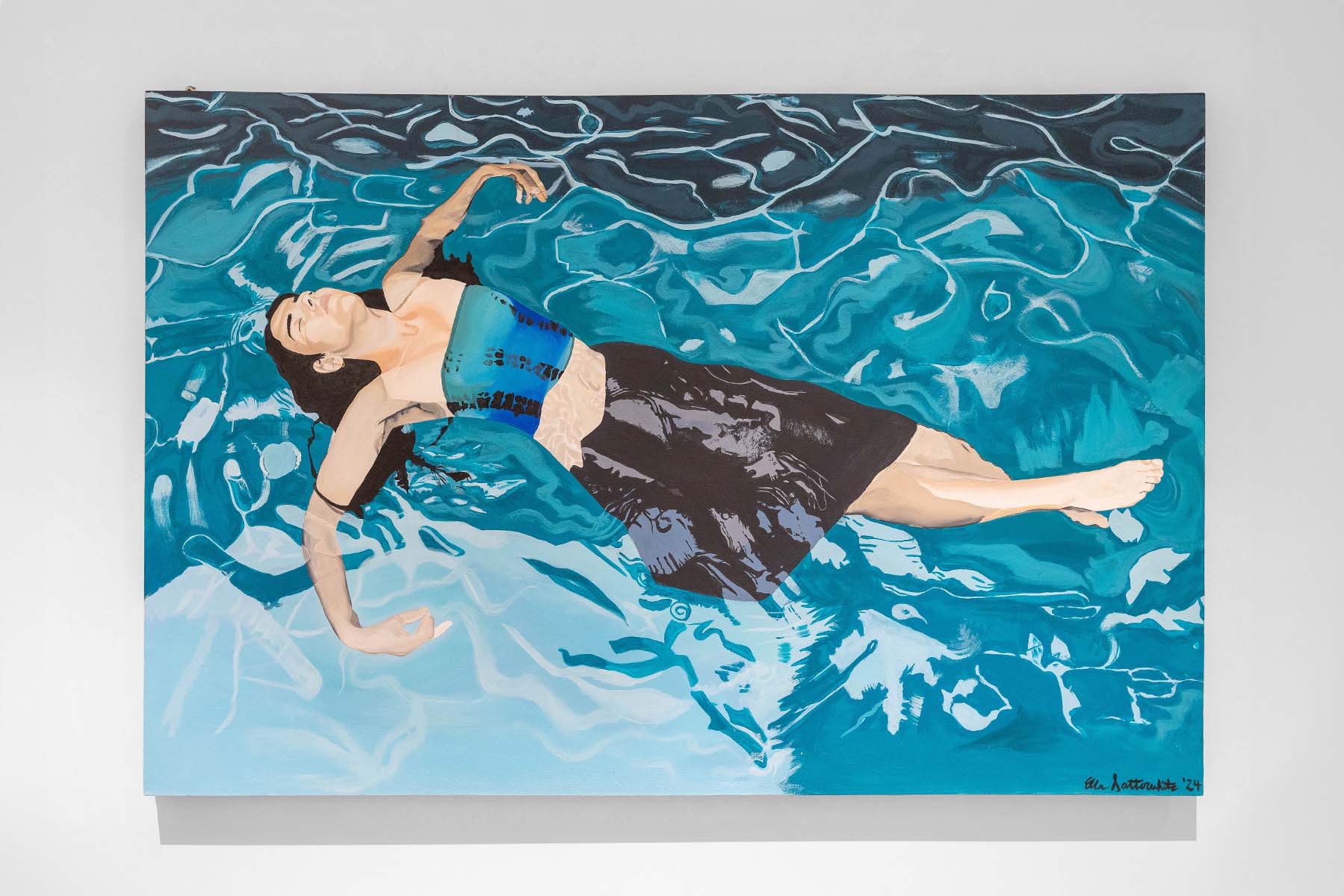Woman lying in a blue pool.