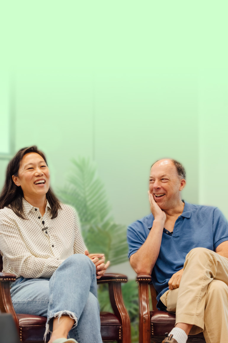 Priscilla Chan and Steve Quake are seated on a panel discussing AI.