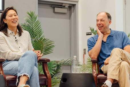 Priscilla Chan and Steve Quake are seated on a panel discussing AI.