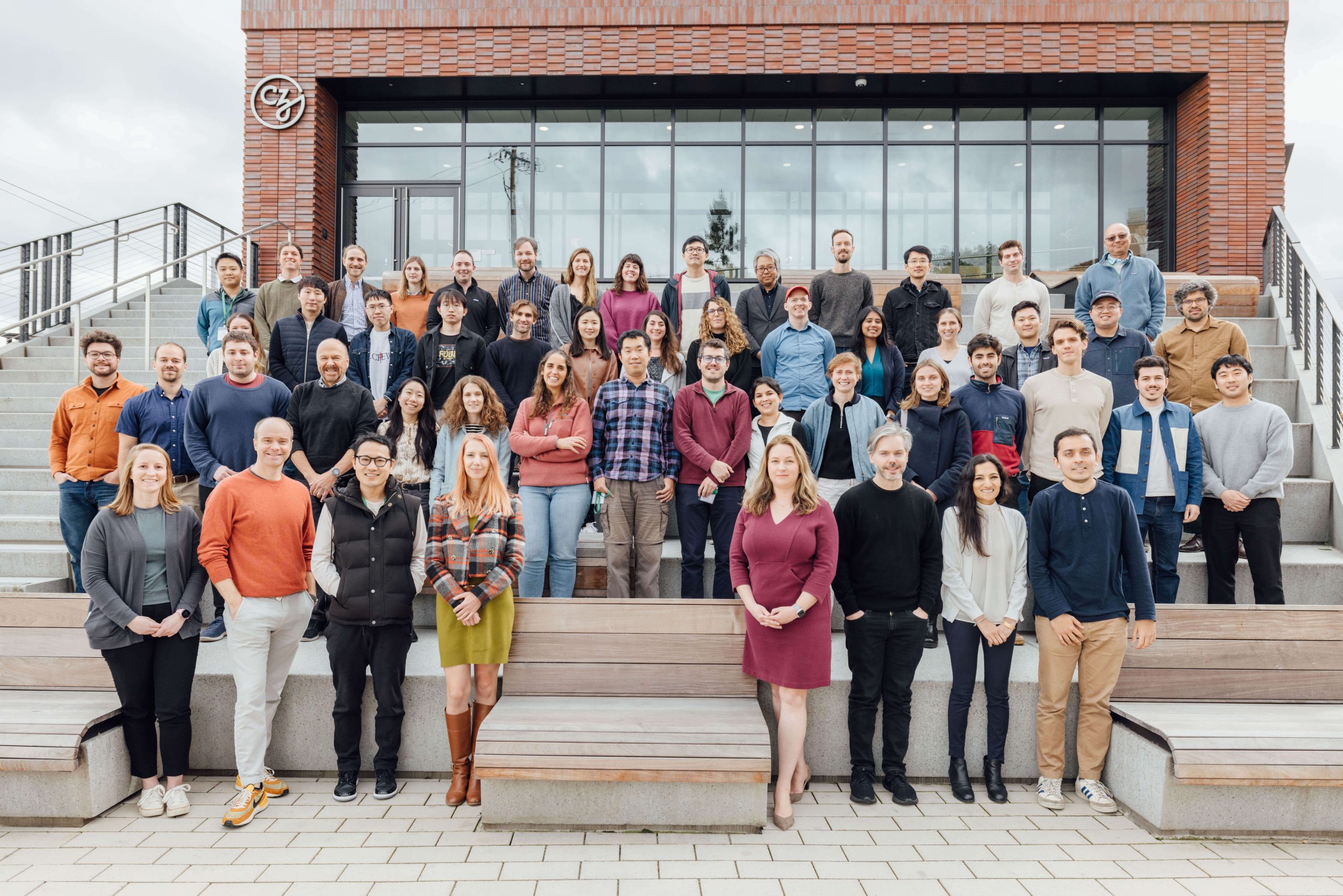 Participants of the AI in Single-Cell Biology Workshop stand outside the CZI building for a group picture on a cloudy morning.