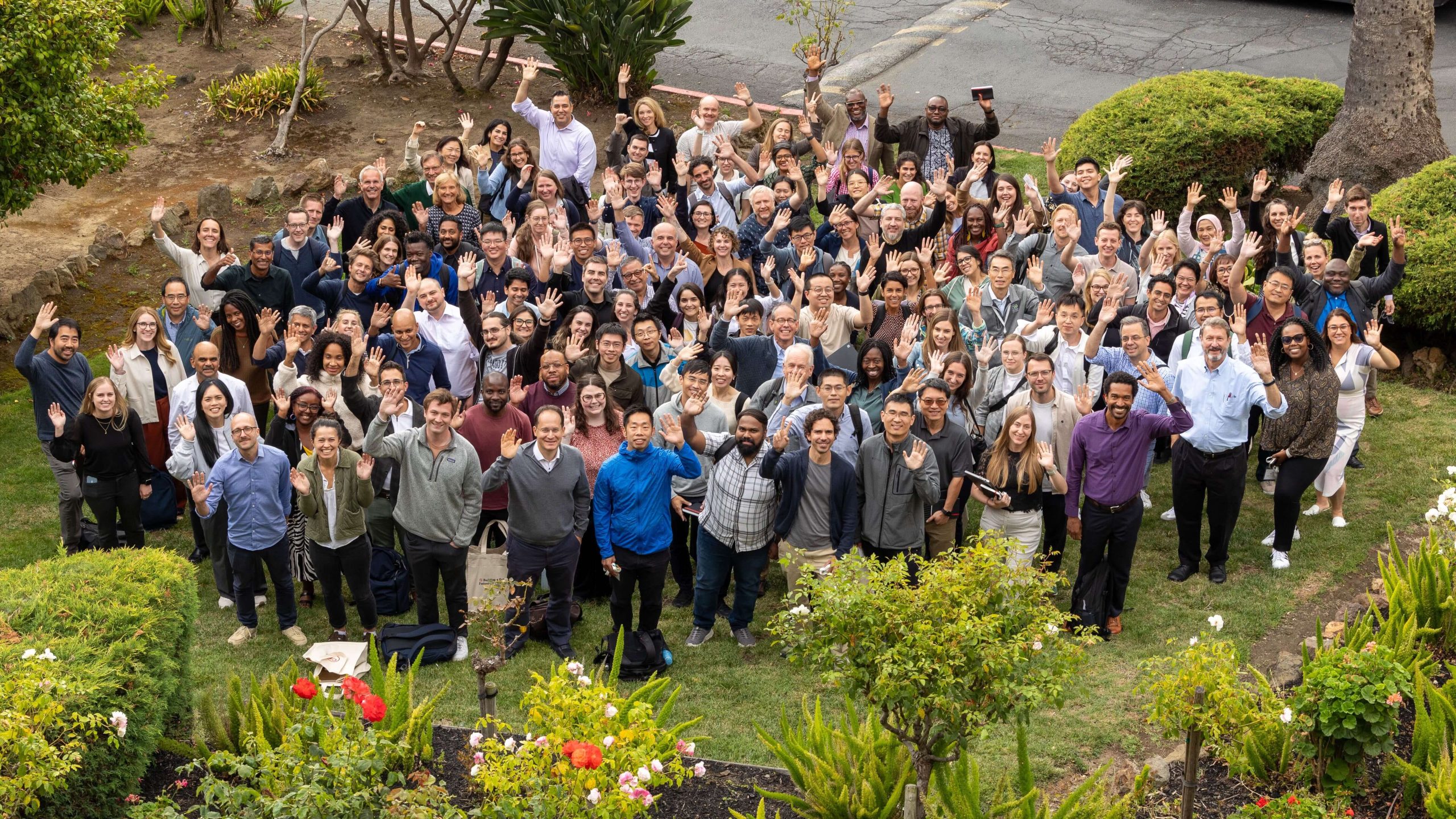 Participants of the Cell Science 2024 Meeting smile and wave up toward the camera.