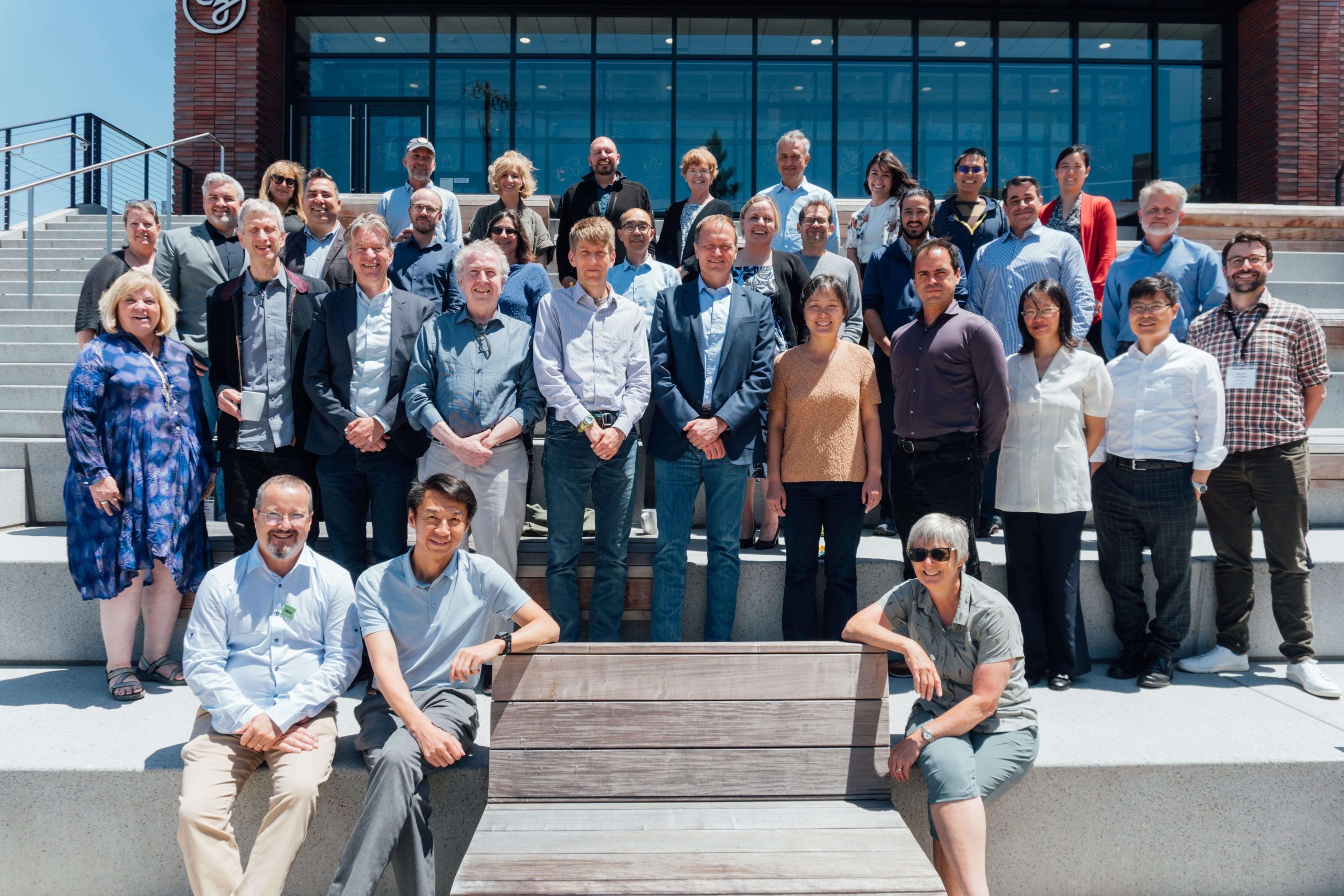 Participants of the CZI Fundamental Neuroscience Workshop: Frontiers of Cellular Neuroscience stand side by side on the steps at the CZI headquarters in Redwood City, CA.