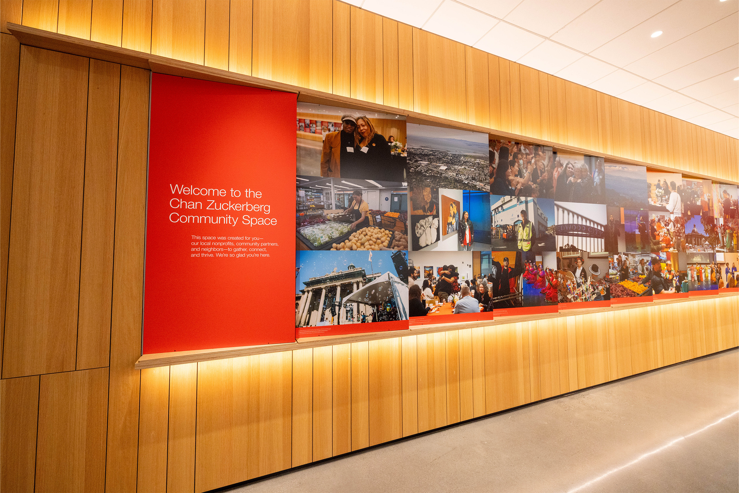 Empty room with large three-dimensional wall display of images and text.