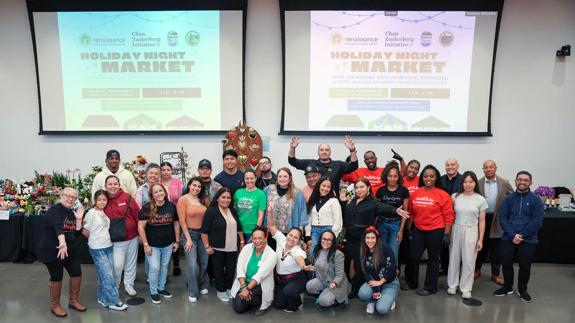 A group of people stand together and smile at the camera.