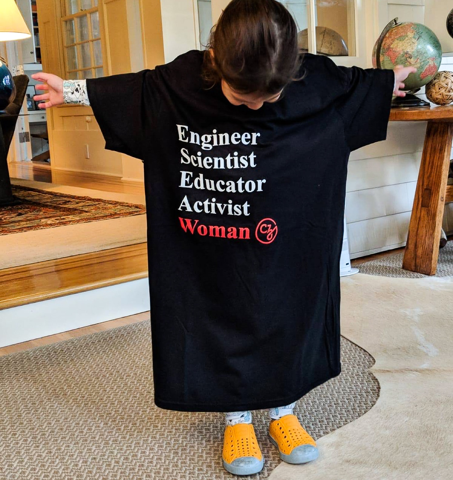 Max tries on Priscilla’s tee shirt from the Grace Hopper Celebration of Women in Computing (CZI Annual Letter).