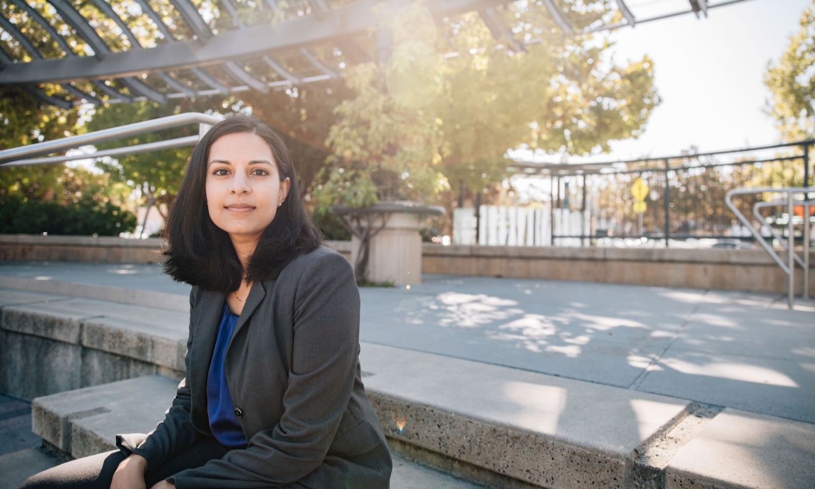 Nila Bala sitting on steps at a park