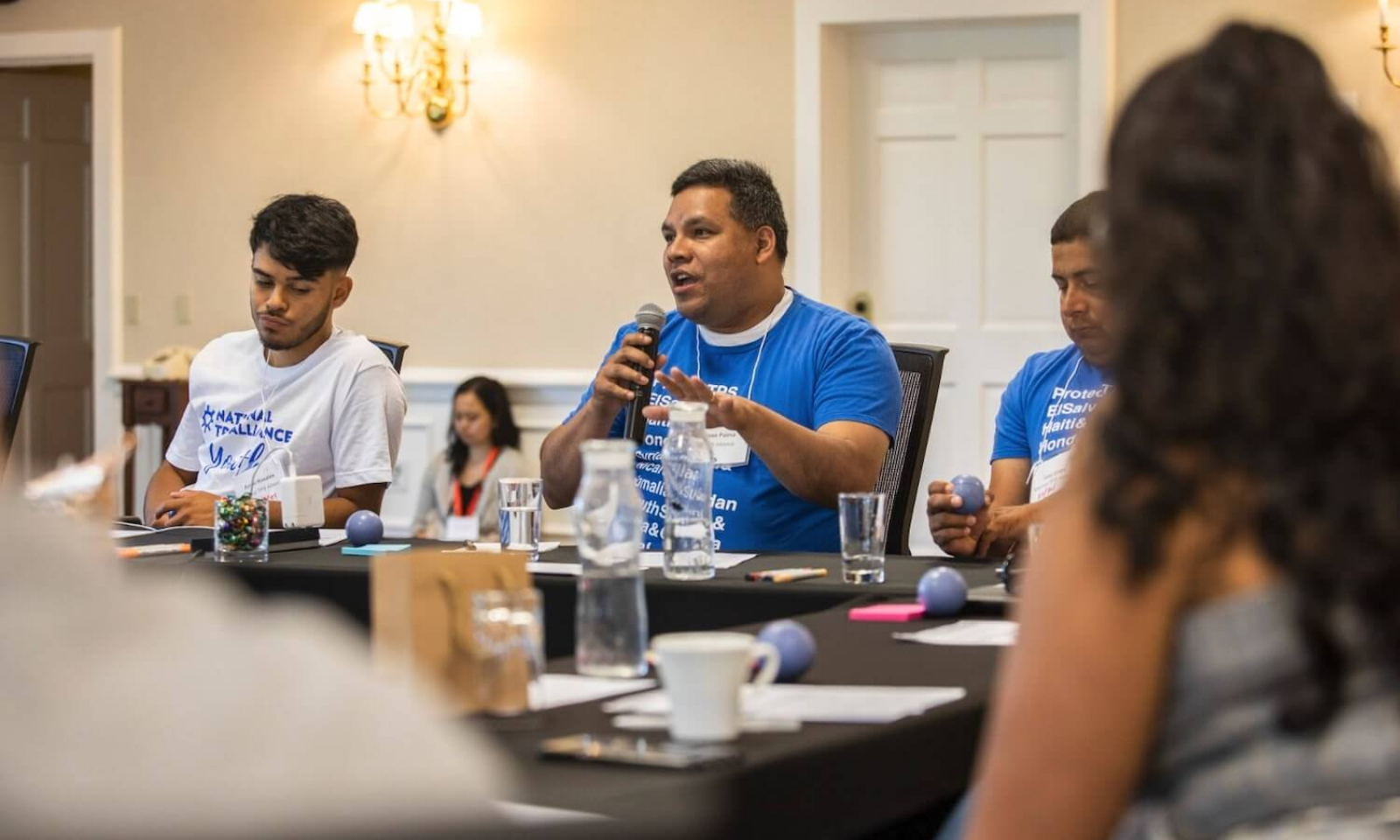 José A. Palma sitting at a table with three people speaking into a microphone