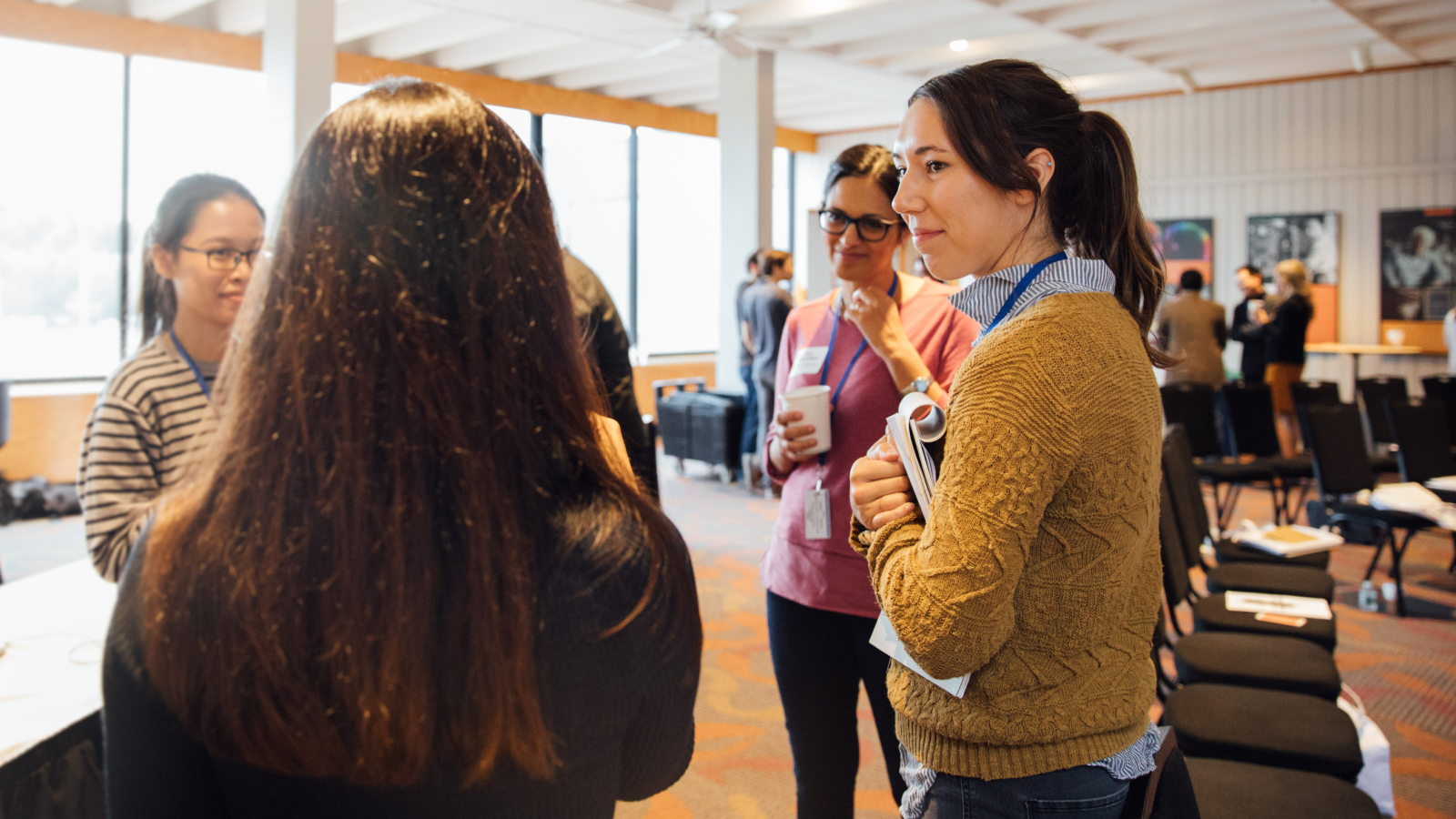 Fiona Griffin of CZI, talking with scientists and researchers at a conference.