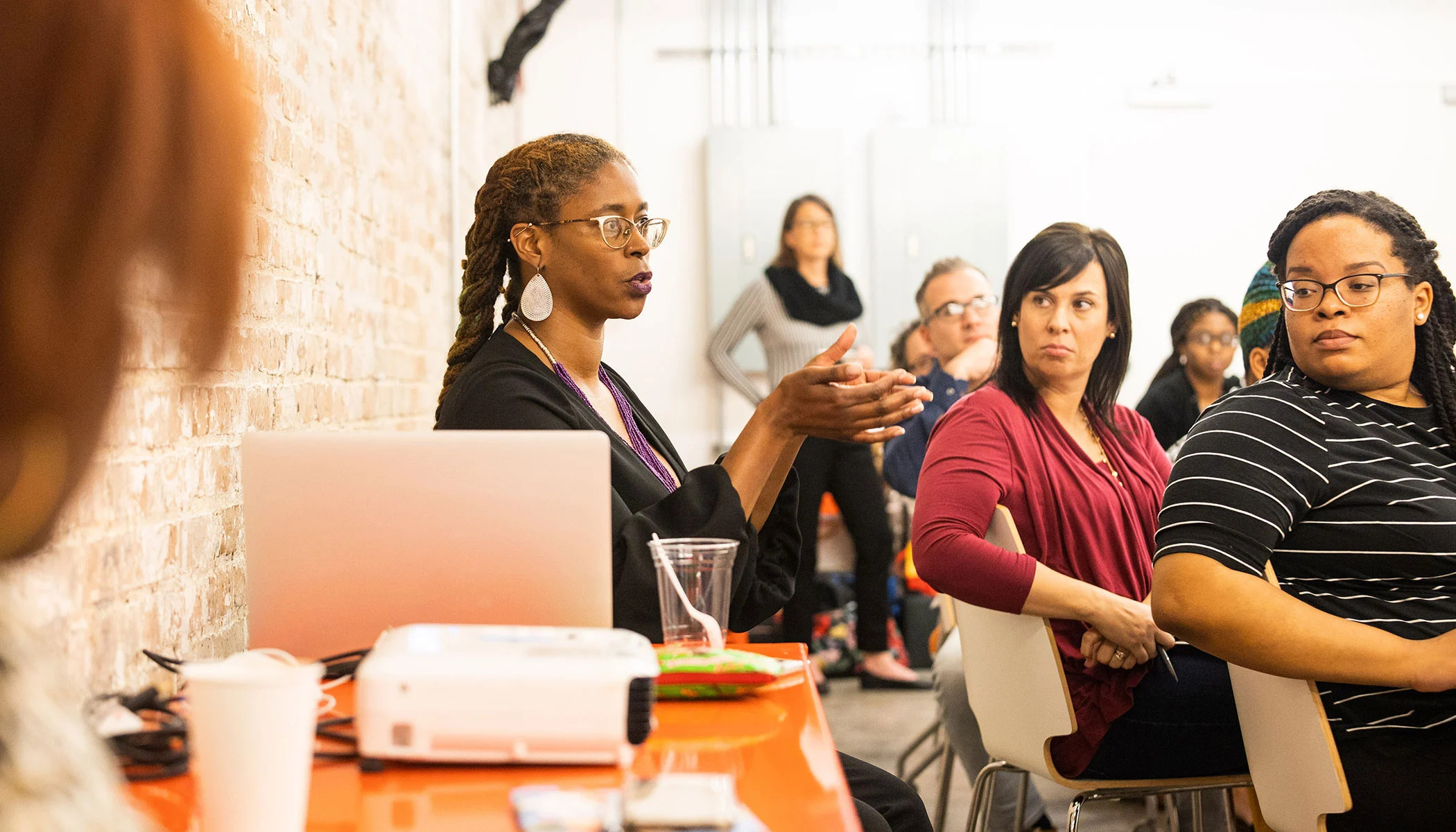 Woman speaking to a room of trainees