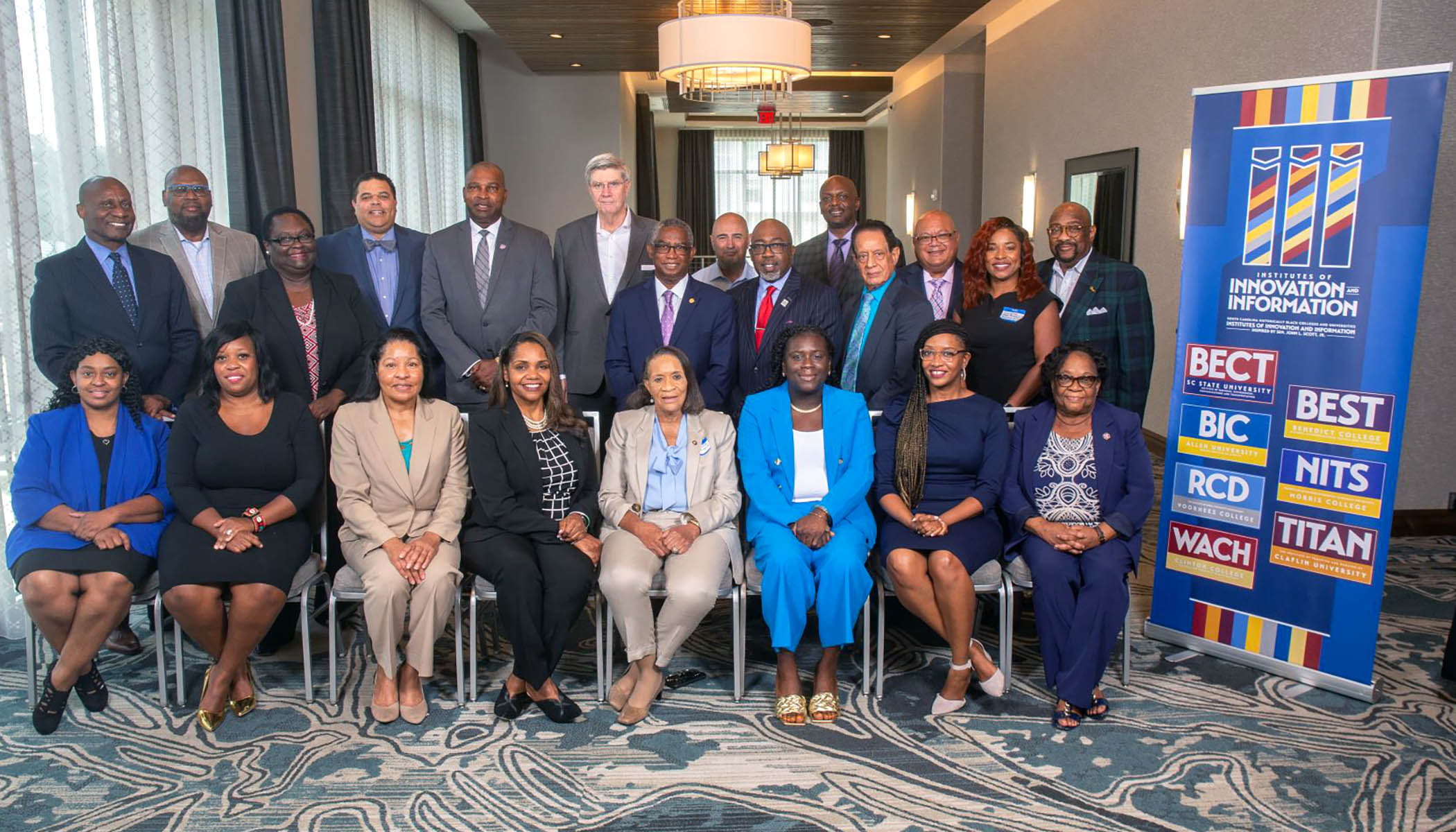 A group photo of Dr. Gwynth R. Nelson and various Institute of Innovation & Information professionals.