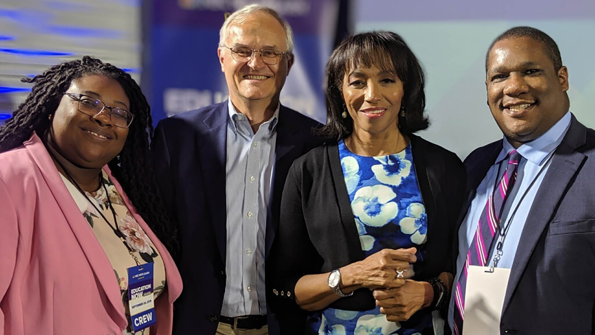 A group of education professionals pose for a picture at a conference.