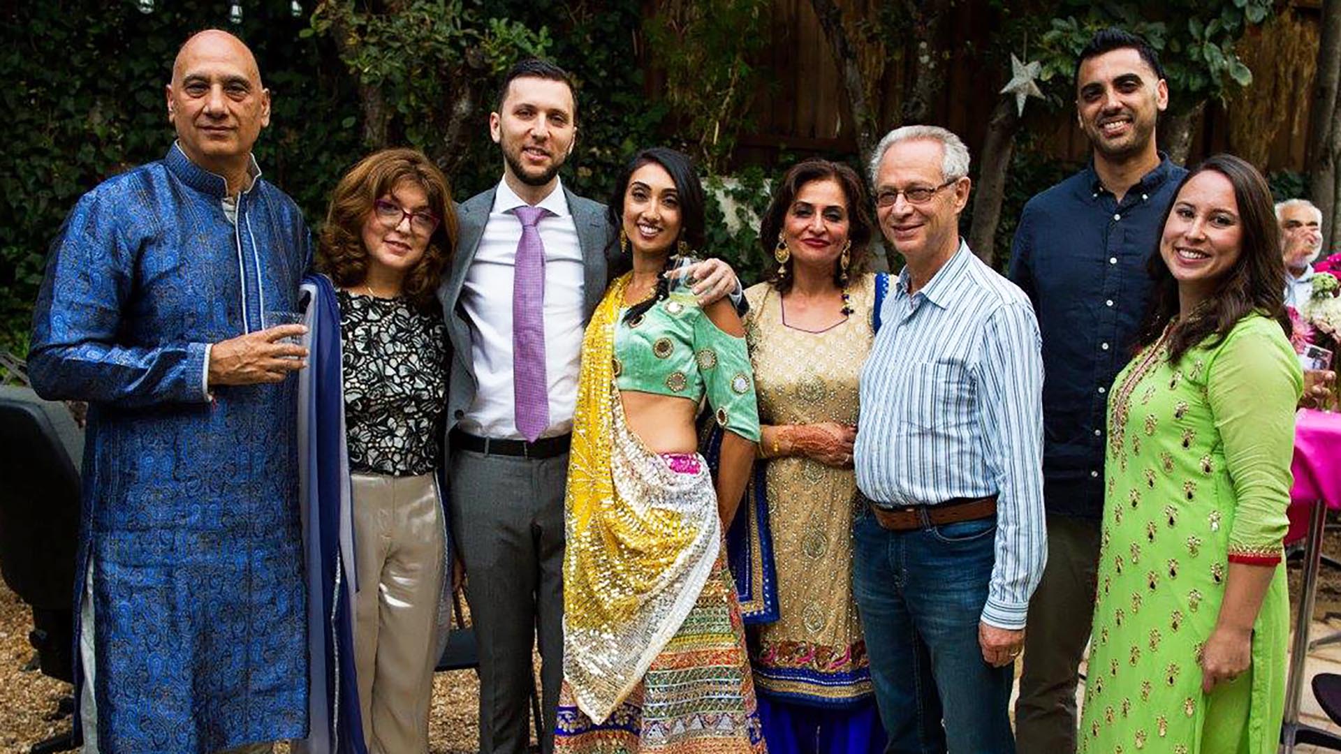 A family poses for a group photo and an outdoor event.