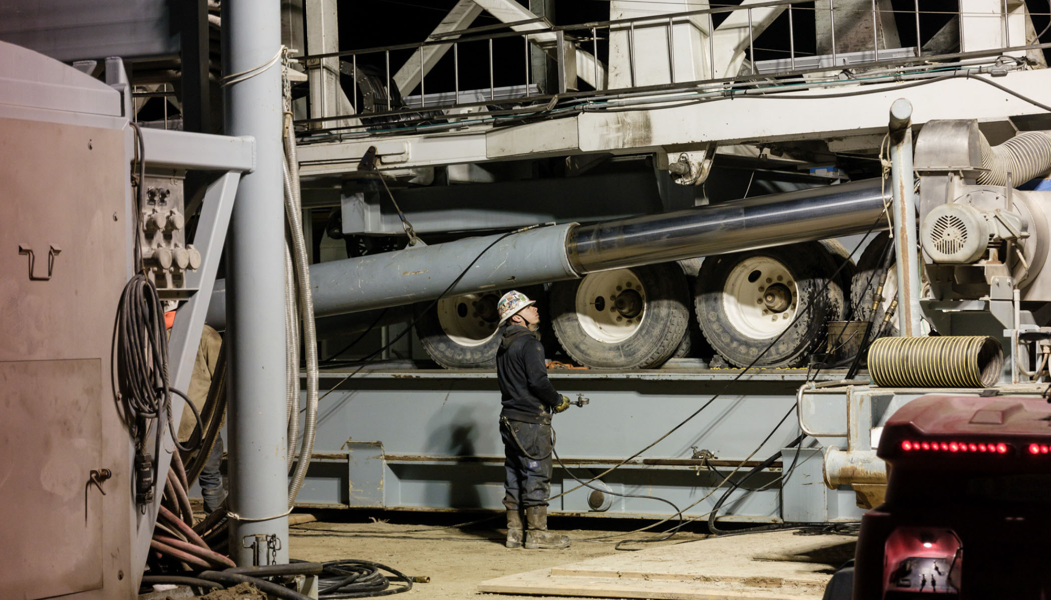 Worker examines drilling rig.