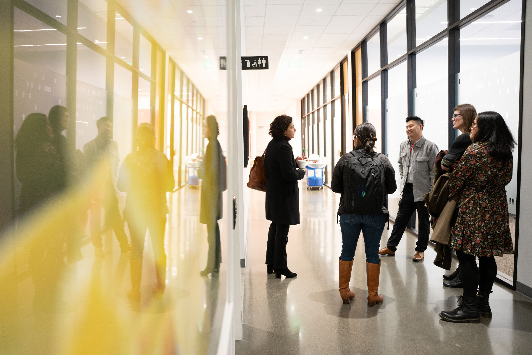 Community Programs Manager Jeremy Nguyen (middle) chats with attendees as they tour the CZI Community Space.
