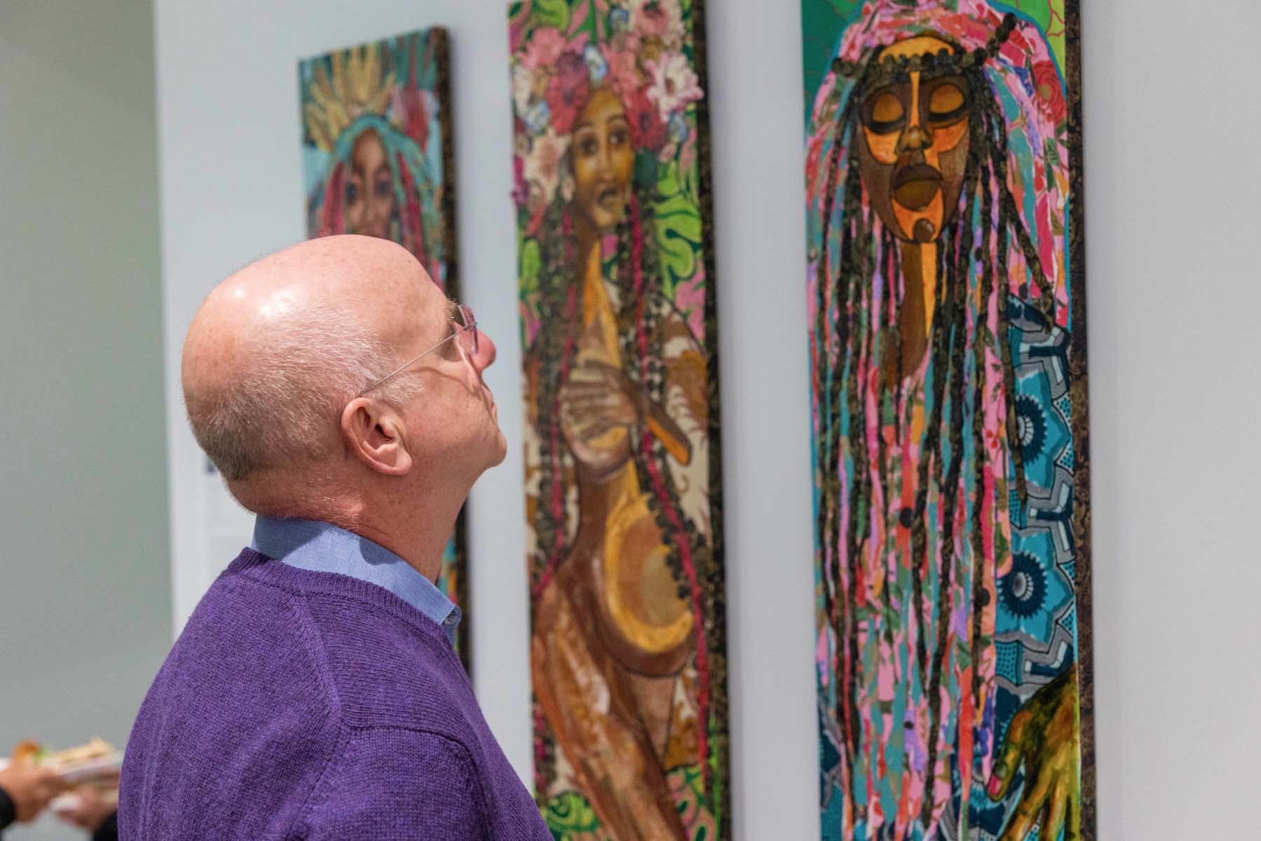 Man looking at art piece.