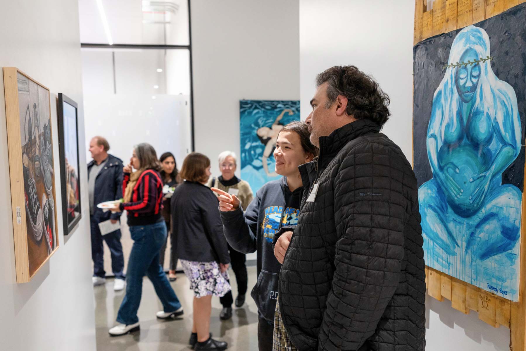 Two people looking at art.