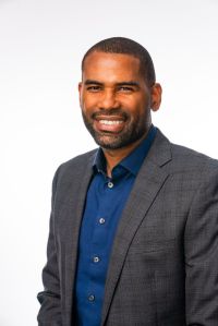 William King, in a grey blazer and blue dress shirt, smiles in a headshot.