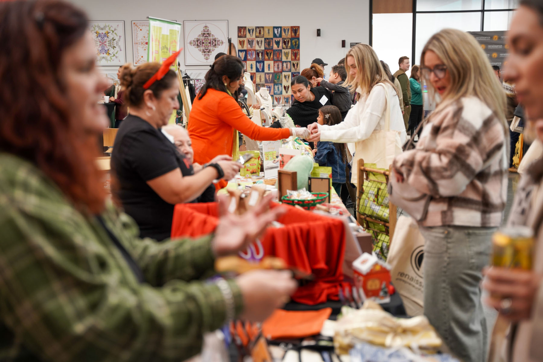 Several shoppers and business owners interact amid a colorful array of products.